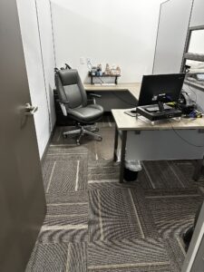 Private office with U-shaped desk and locking door created with floor to ceiling cubicle wall panels installed in Nebraska by Green Clean Designs