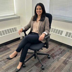 Professional woman in Steelcase Leap v2 ergonomic office chair with lumbar support for back pain