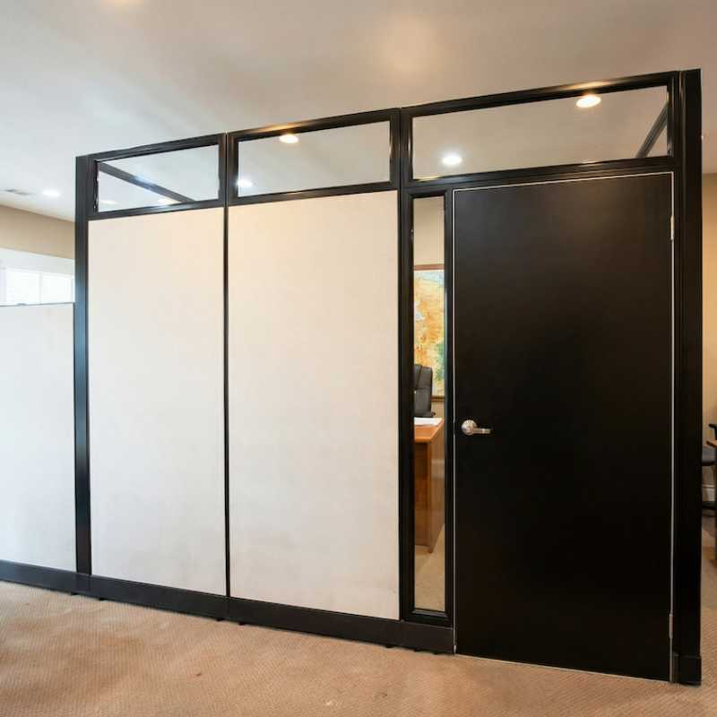 Private office cubicle with locking door and glass clerestory panels in black frame installed for an insurance office in Minnesota by Green Clean Designs