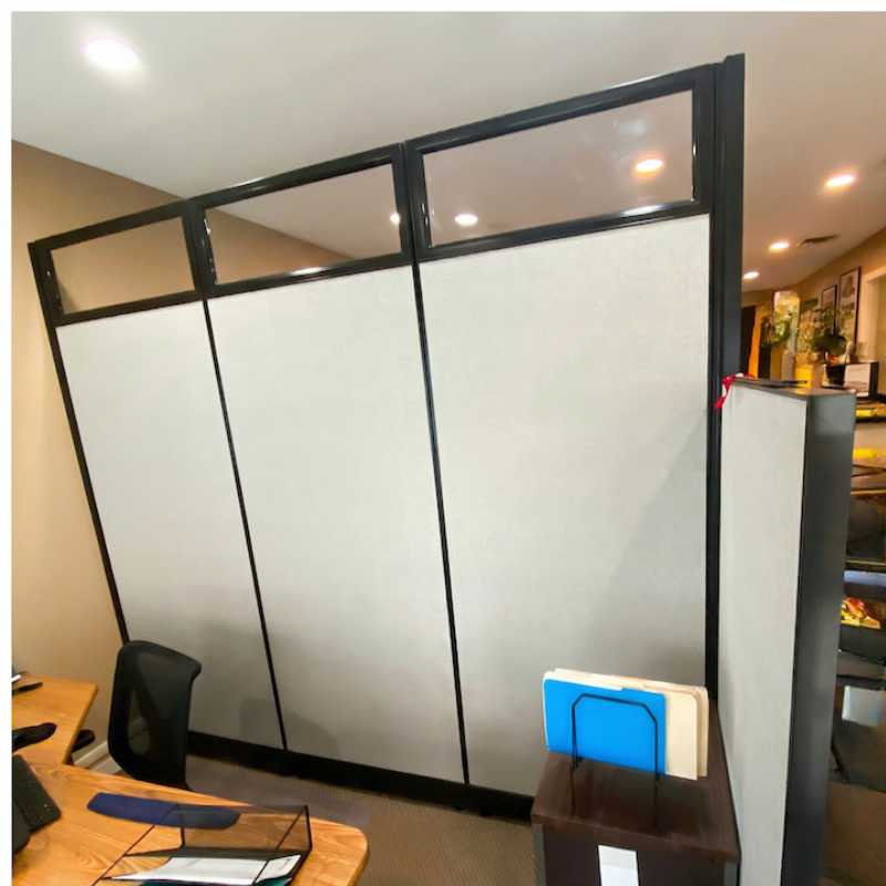 Side view of 99 inch tall cubicle office with shorter panel extending from the front creating a semi-private workspace area for an insurance office in Minnesota by Green Clean Designs